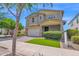 Inviting two-story home with a tidy lawn, neutral colors and a two-car garage at 9839 E Theia Dr, Mesa, AZ 85212