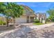 Well-maintained two-story home featuring desert landscaping, a two-car garage, and a welcoming entrance at 9839 E Theia Dr, Mesa, AZ 85212