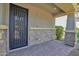 A welcoming front porch with stone accents and a stylish front door provides curb appeal at 9839 E Theia Dr, Mesa, AZ 85212