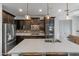 Modern kitchen with dark cabinets, island, and stainless steel appliances at 9839 E Theia Dr, Mesa, AZ 85212