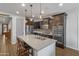 Modern kitchen with dark cabinets, island, and stainless steel appliances at 9839 E Theia Dr, Mesa, AZ 85212