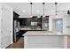 Well-lit kitchen features stainless steel appliances, dark cabinetry, tiled backsplash, and a large island at 9839 E Theia Dr, Mesa, AZ 85212