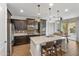 Modern kitchen with dark cabinets, island, and stainless steel appliances at 9839 E Theia Dr, Mesa, AZ 85212