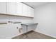 The bright laundry room offers tiled floors, tons of cabinet space, and a workspace at 9839 E Theia Dr, Mesa, AZ 85212