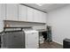 Laundry room with washer, dryer and storage cabinets at 9839 E Theia Dr, Mesa, AZ 85212