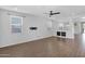 Bright and airy living room with ample natural light, wood-look floors, and open floor plan at 9839 E Theia Dr, Mesa, AZ 85212
