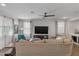 Bright living room, featuring a sectional sofa and ceiling fan at 9839 E Theia Dr, Mesa, AZ 85212