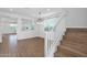 Open-concept living area with wood-look floors, neutral paint, and a staircase at 9839 E Theia Dr, Mesa, AZ 85212