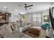 Spacious living room with sectional sofa and large TV at 9839 E Theia Dr, Mesa, AZ 85212