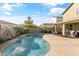 Relaxing kidney shaped pool with patio furniture and fire pit at 9839 E Theia Dr, Mesa, AZ 85212