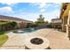 Backyard oasis with kidney shaped pool, fire pit, and water features at 9839 E Theia Dr, Mesa, AZ 85212
