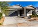 Modern single story home with gray siding, white accents and a covered porch at 10032 E Toledo Ave, Mesa, AZ 85212