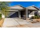 Modern single story home with gray siding, white accents and a covered porch at 10032 E Toledo Ave, Mesa, AZ 85212