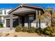 Modern single story home with gray siding, white accents and a covered porch at 10032 E Toledo Ave, Mesa, AZ 85212