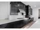 Modern kitchen with dark cabinetry, stainless steel appliances, and white subway tile at 10032 E Toledo Ave, Mesa, AZ 85212