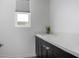 Laundry room with quartz countertop and dark cabinetry at 10032 E Toledo Ave, Mesa, AZ 85212