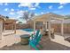 Inviting backyard with a sparkling pool, pergola, and fire pit at 10869 W Alex Ave, Sun City, AZ 85373