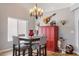 Small dining area with a red cabinet and a chandelier at 10869 W Alex Ave, Sun City, AZ 85373