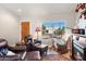 Comfortable living room featuring leather seating and a fireplace at 10869 W Alex Ave, Sun City, AZ 85373