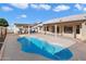 Relaxing pool area featuring a freeform pool and patio seating at 10869 W Alex Ave, Sun City, AZ 85373