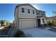 Two-story house with attached garage and neutral color exterior at 10993 W Pierce St, Avondale, AZ 85323