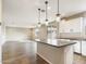 Modern kitchen with white cabinets, gray countertops, and an island at 10993 W Pierce St, Avondale, AZ 85323