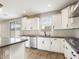 Modern kitchen with white cabinets, gray countertops, and island at 10993 W Pierce St, Avondale, AZ 85323