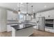 Modern kitchen with white cabinets, stainless steel appliances, and an island at 10993 W Pierce St, Avondale, AZ 85323