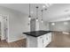 Kitchen island with dark countertop and white cabinets at 10993 W Pierce St, Avondale, AZ 85323