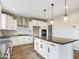 Modern kitchen with white cabinets, gray countertops, and an island at 10993 W Pierce St, Avondale, AZ 85323