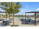 Relaxing pool area with tables, chairs, and umbrellas at 10993 W Pierce St, Avondale, AZ 85323