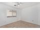 Simple bedroom with tile floors and a ceiling fan at 11640 W Duran Ave, Youngtown, AZ 85363