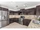 Updated kitchen, featuring dark cabinetry and granite counters at 11640 W Duran Ave, Youngtown, AZ 85363