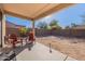 Covered patio with chairs and small backyard at 1227 W Delmonte Dr, Casa Grande, AZ 85122