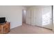 Bedroom with a TV stand and sliding door closet at 1227 W Delmonte Dr, Casa Grande, AZ 85122