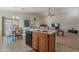 Kitchen with island and adjacent dining area with floral chairs at 1227 W Delmonte Dr, Casa Grande, AZ 85122