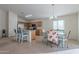 Bright dining area with floral chairs and view of kitchen at 1227 W Delmonte Dr, Casa Grande, AZ 85122