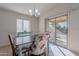 Bright dining room features a table with floral chairs and access to a patio at 1227 W Delmonte Dr, Casa Grande, AZ 85122