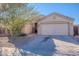 Single story house with a two-car garage and desert landscaping at 1227 W Delmonte Dr, Casa Grande, AZ 85122