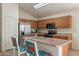 Kitchen with island, stainless steel appliances, and wood cabinets at 1227 W Delmonte Dr, Casa Grande, AZ 85122