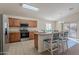 Kitchen with island, stainless steel appliances, and wood cabinets at 1227 W Delmonte Dr, Casa Grande, AZ 85122