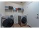 Laundry room with washer, dryer and shelving at 1227 W Delmonte Dr, Casa Grande, AZ 85122