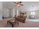 Open concept living room with view into kitchen and dining area at 1227 W Delmonte Dr, Casa Grande, AZ 85122