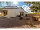 House exterior showcasing a spacious backyard with gravel landscaping and a covered patio at 12677 N 140Th Dr, Surprise, AZ 85379