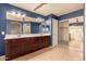 Double vanity bathroom with dark wood cabinets and walk-in shower at 12677 N 140Th Dr, Surprise, AZ 85379