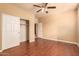 Bedroom with hardwood floors, ceiling fan and closet at 12677 N 140Th Dr, Surprise, AZ 85379