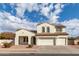 Two-story house with white exterior, three-car garage, and landscaped yard at 12677 N 140Th Dr, Surprise, AZ 85379