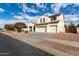 Two-story house with white exterior, three-car garage, and landscaped yard at 12677 N 140Th Dr, Surprise, AZ 85379