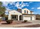 Two-story house with white exterior, three-car garage, and landscaped yard at 12677 N 140Th Dr, Surprise, AZ 85379