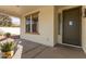 Front porch with dark brown door and sidelights at 12677 N 140Th Dr, Surprise, AZ 85379